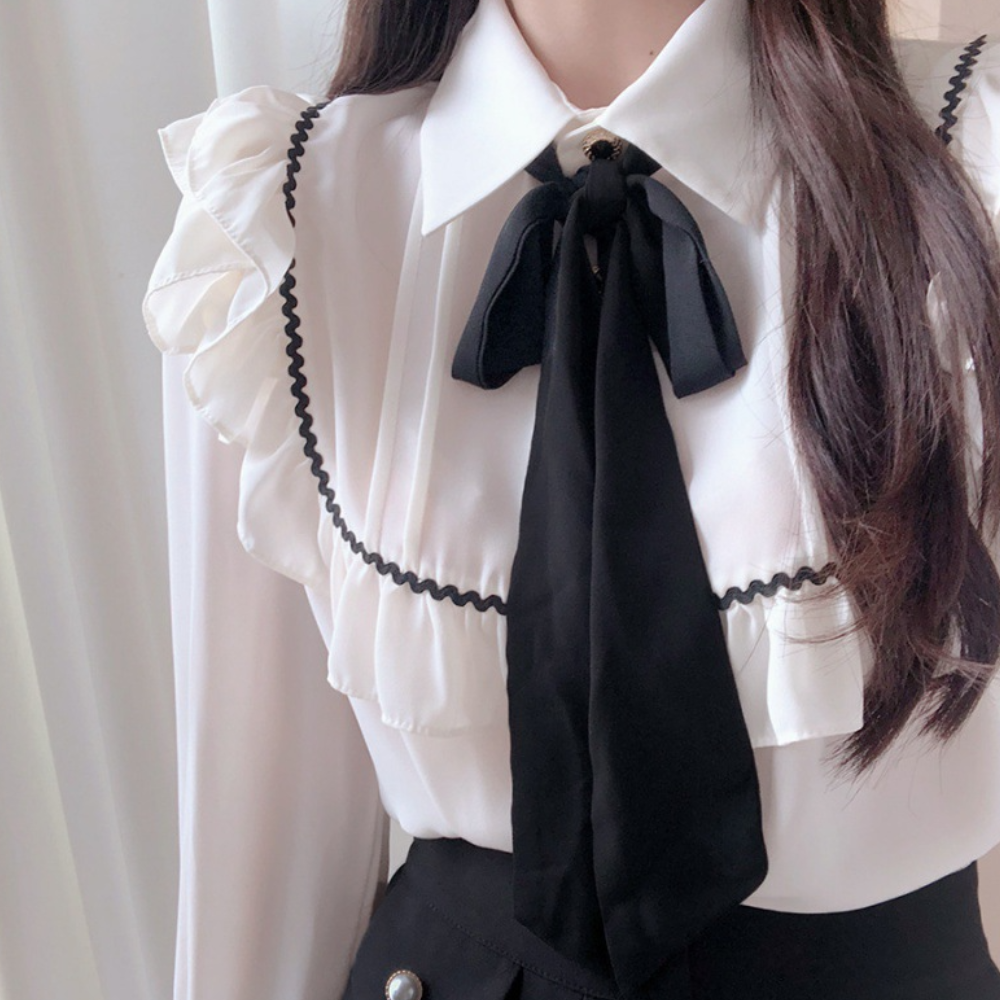 Suri® | Elegant women's blouse with charming ruffles and a thin bow