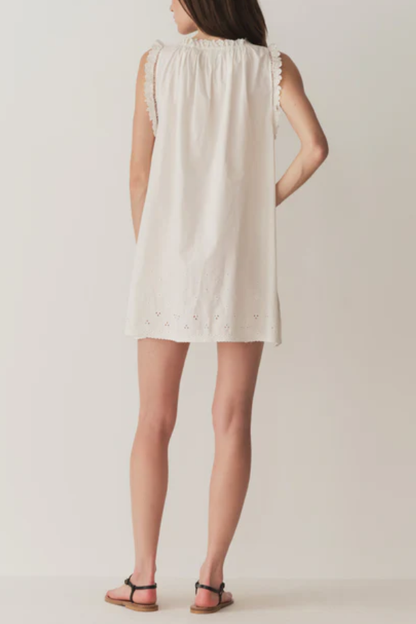 Trista® | Short skirt with pearl buttons, scalloped hem and round neckline.